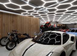 Motorcycles and sports vehicles in commercial spaces with modern lighting.