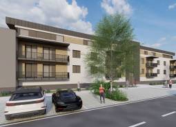 Construction of apartments in Kriváň with cars and people on the street near the apartment building.