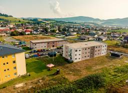 The construction of apartments in Kriváň surrounded by countryside and family houses.