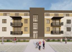 The construction of apartments in Kriváň includes a modern building with balconies and greenery around.