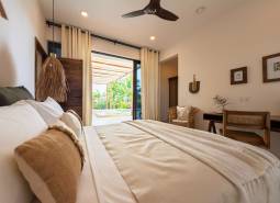 Bedroom interior with a spacious bed and a view of the terrace, House construction.