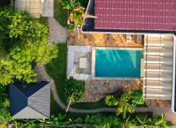 Aerial view of house construction with a swimming pool in the suburb of Paje, Unguja South Region.