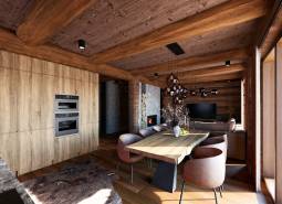 Interior of house construction with wood-patterned flooring, wooden beams, and a fireplace.