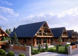 Construction of houses in Nová Lesná with wooden elements and stone fences.