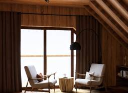 Interior with two chairs, a lamp, and a wooden-patterned floor. House construction.