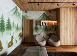 Interior with a wall mural of a forest, seating, and wood-patterned flooring for home construction.