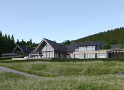 Modern buildings surrounded by nature in development plots near Tajov.