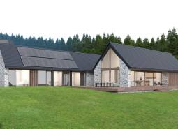Stone house in Tajov with photovoltaic panels on the roof, surrounded by forest. Development plots.