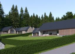 Development plots in Tajov with modern family houses and a forest backdrop.
