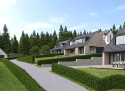 Development plots in Tajov with modern houses surrounded by forest and greenery.