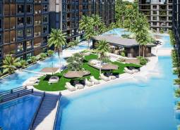 The construction of apartments in Pattaya with pools, loungers, and palm trees creates a holiday atmosphere.