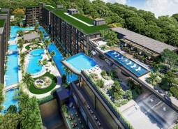 Apartment construction in Pattaya, featuring swimming pools and terraces with surrounding greenery.