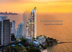 A view of apartment construction in Pattaya with a sea view at sunset.