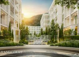 Apartment construction in Phuket with elegant architecture and landscaped greenery in the exterior.