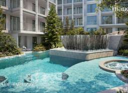 A swimming pool and jacuzzi surrounded by greenery during the construction of apartments in Phuket.