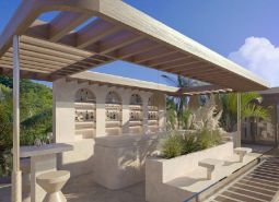 In Nungwi, there is a terrace with a bar in the villa, surrounded by palm trees and greenery.