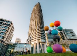In Bratislava on Pribinova Street, there is a tall building with a colorful sculpture.