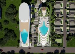 Aerial view of apartment construction in Phuket with a pool and villas.
