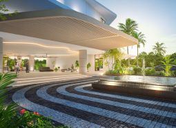 Architectural entrance with a garden and fountain. The apartment development in Phuket offers a luxurious environment.