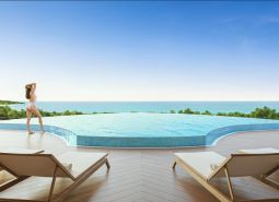 A pool with a sea view and sun loungers, Apartment construction in Phuket.