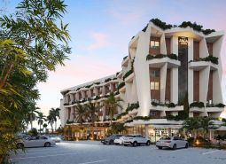 Residential complex in Paje, Unguja South, surrounded by greenery, parking in front of the building.