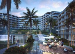 Apartment construction in Phuket with a terrace, palm trees, and an illuminated complex.