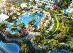Apartment construction in Phuket with pools amidst greenery and palm trees.