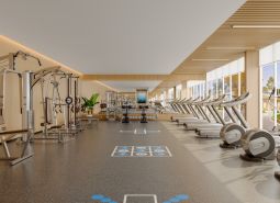 A fitness center with machines and treadmills in the apartment complex Výstavba bytov.