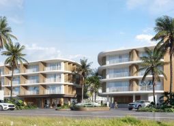 Construction of apartments in Surat Thani with palm trees and modern architecture.