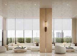 Interior with light furniture, large windows, and a wooden decor floor. Apartment construction.