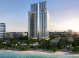 Apartment construction in Pattaya with a view of the beach and ocean.
