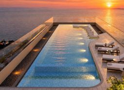 Rooftop pool with a view of the coastline as part of the apartment construction in Pattaya.