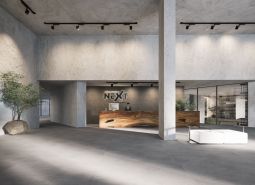 A spacious hall with a reception and minimalist furniture, part of an apartment construction.