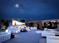 View of the exterior space of apartment construction in Phuket with an outdoor cinema.
