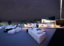 Rooftop terrace with seating and large screen, Apartment construction in Phuket.