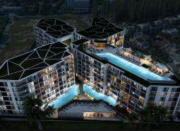 Apartment construction in Phuket: Modern complex with a pool in a nighttime setting.