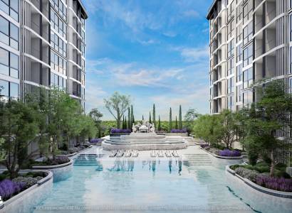 The construction of apartments in Pattaya includes a pool and gardens between the buildings.