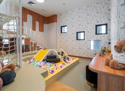 Children's corner with a ball pool and games as part of apartment construction.