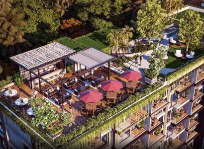 Rooftop garden with a terrace in a residential complex in Pattaya surrounded by greenery.