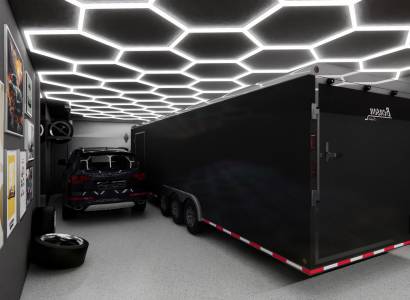 Commercial space with a car, trailer, light ceiling, and art posters on the wall.