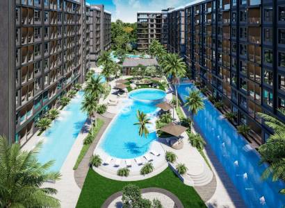 The construction of apartments in Pattaya with swimming pools, terraces, and palm trees creates a tropical atmosphere.