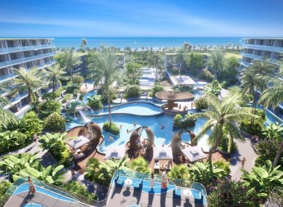 Apartment construction in Phuket with a swimming pool, palm trees, and a sea view.
