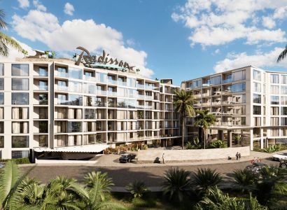 Apartment construction in Phuket with green vegetation, modern architecture, and glass sections.