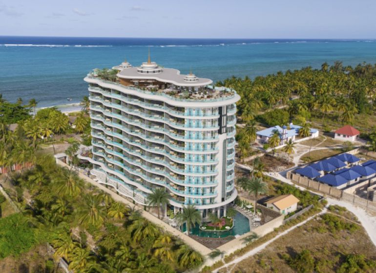 Beachfront apartment complex in Paje with ocean views and palm trees.