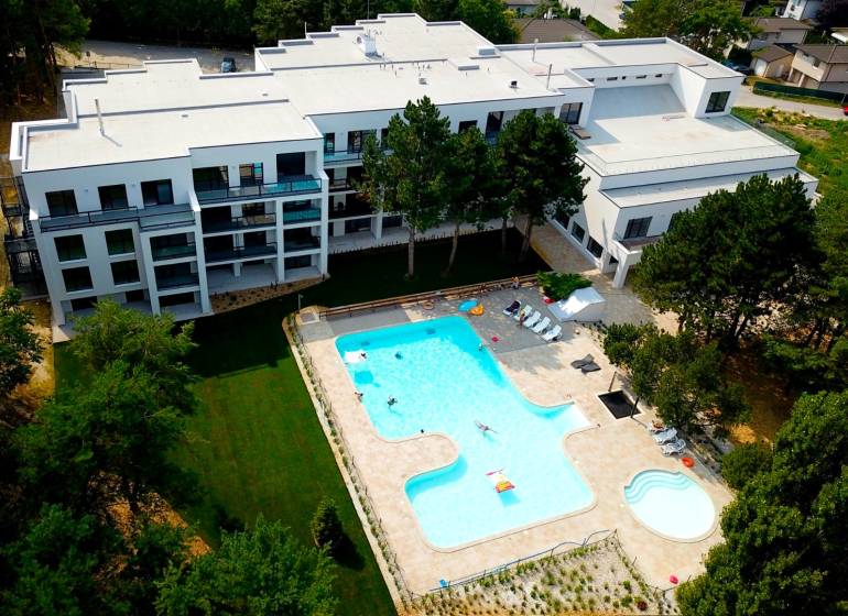 In Piešťany on Rekreačná, there is a complex with a pool surrounded by greenery and modern architecture.