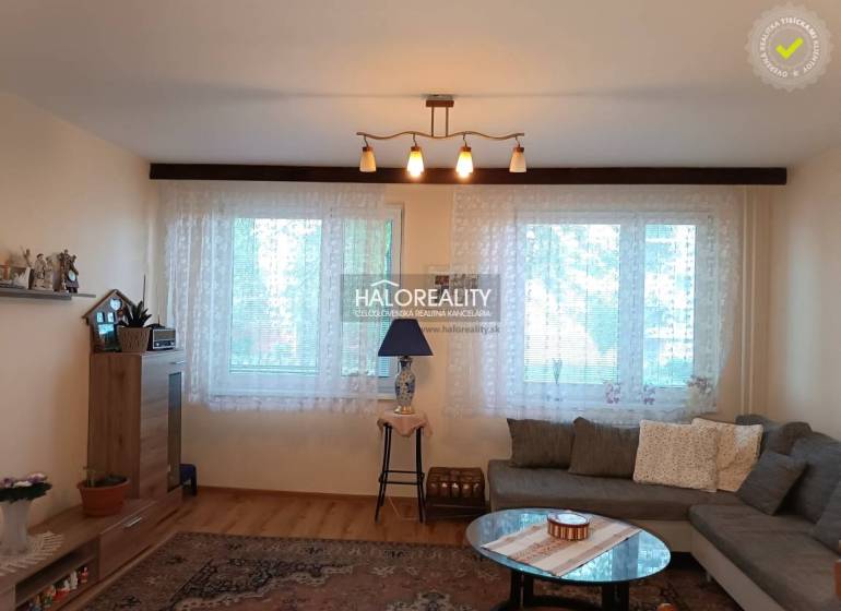 Living room in a 3-room apartment with a sofa, table, and shelf.