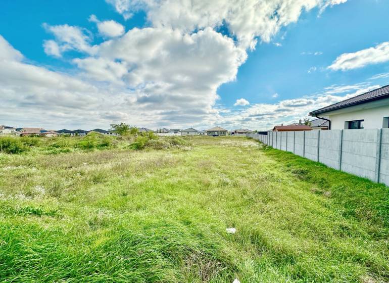 Residential plots at Južná Brána in Senec with grassy area and blue sky.