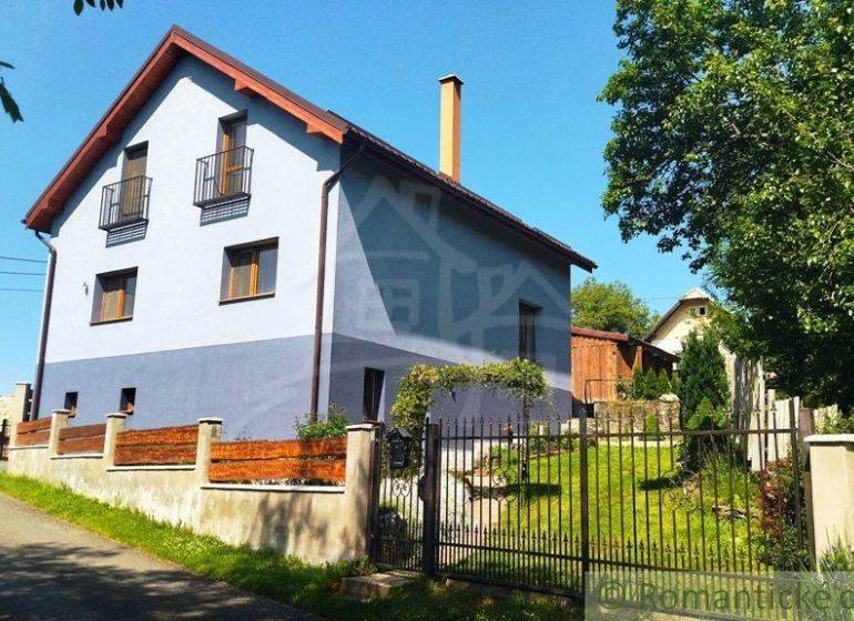 A family house in Spišská Nová Ves with a garden and fencing on a quiet street.