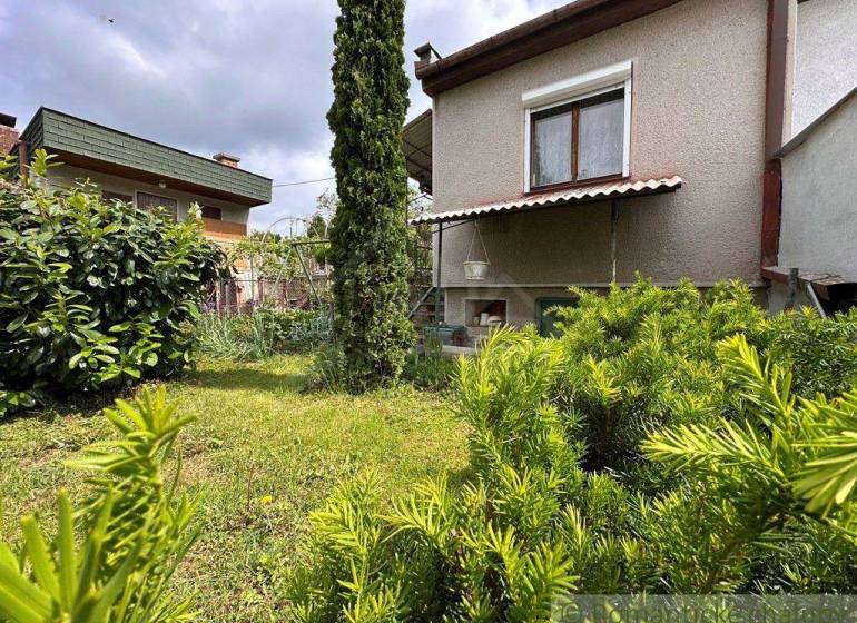 A cottage in Nové Zámky surrounded by greenery and a landscaped garden.