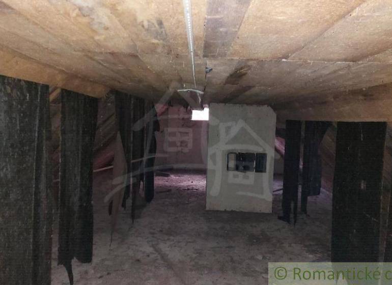 The attic of a family house with wooden beams, suitable for renovation.